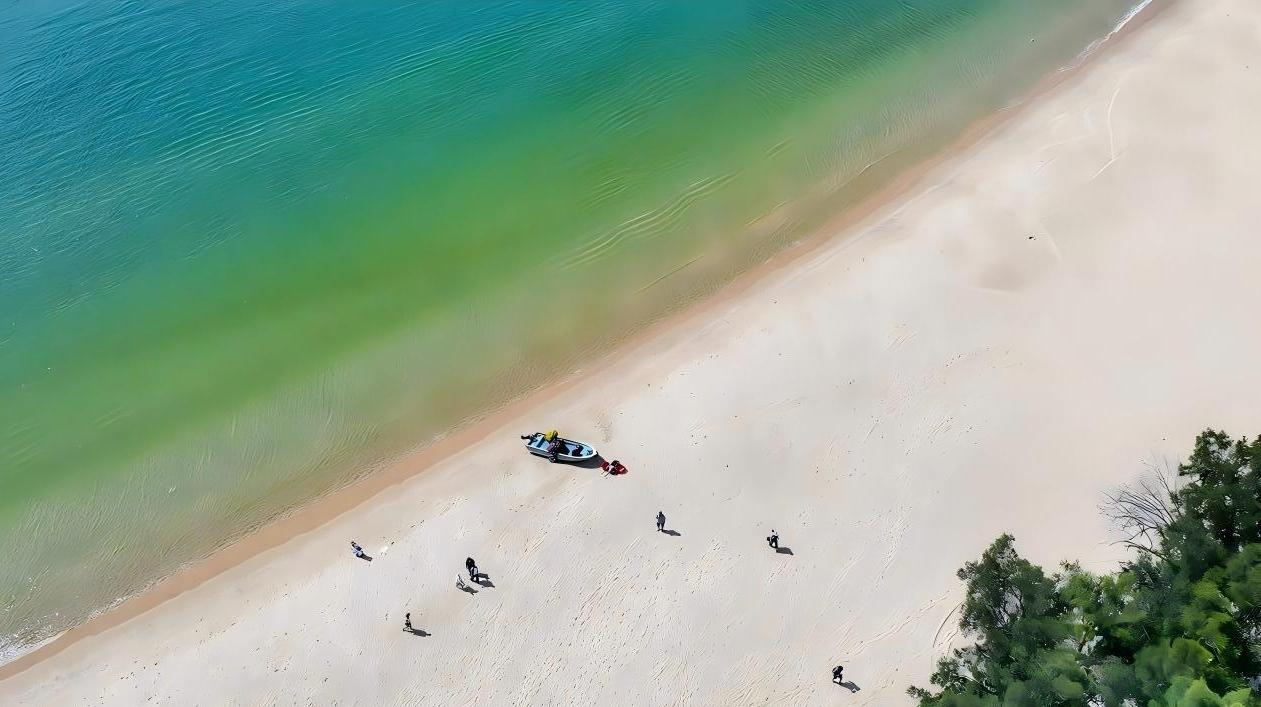 Azure seas cradle the shore, gentleness whispering to the soul