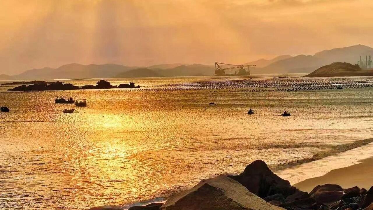 Evening glow over the sea, reef shores in gold