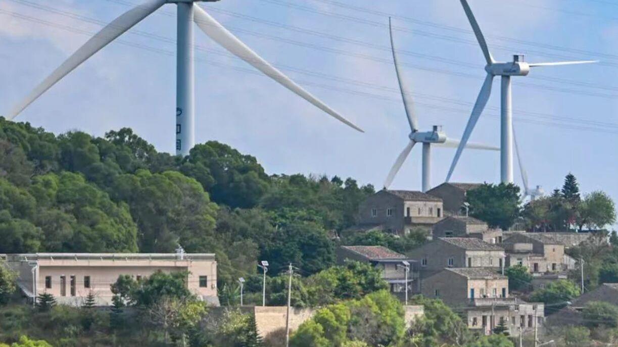 Green peaks rise, clouds kiss stone cottages